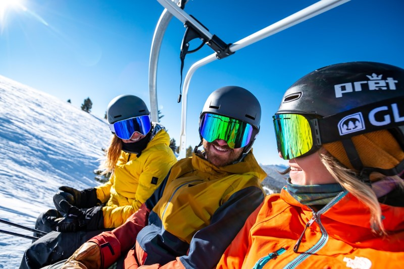 This image has an empty alt attribute; its file name is Skiers-on-chairlift-closeup.png